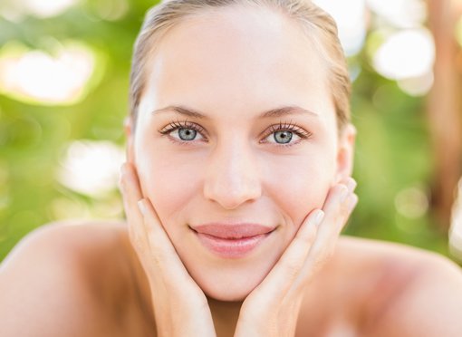 facial fillers patient model with her hands against her cheeks