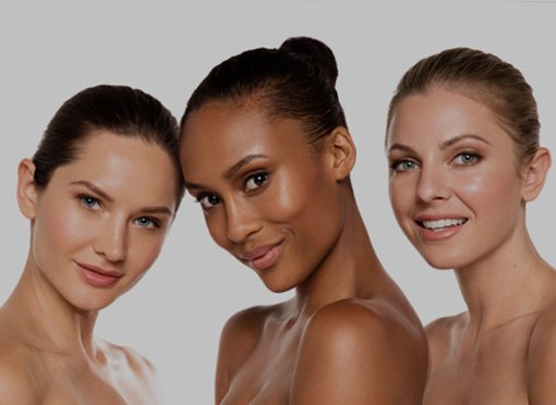 three pretty microdermabrasion patient models smiling with their shoulders bare