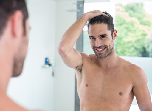 male plastic surgery patient model looking at the mirror