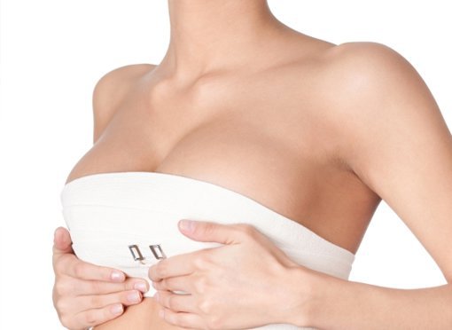 breast surgery patient model with her hand under her breasts