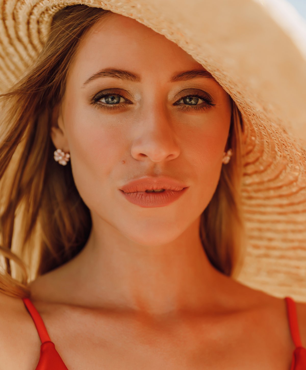 Morpheous8 rf microneedling patient model wearing a sunhat and red bikini top