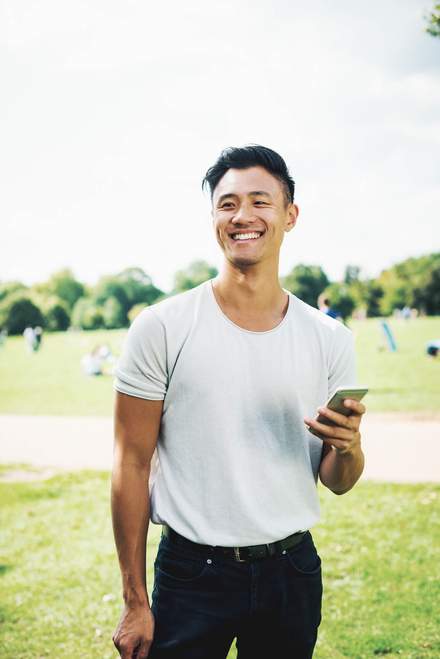 smiling brow lift for men patient model in a white shirt at a park